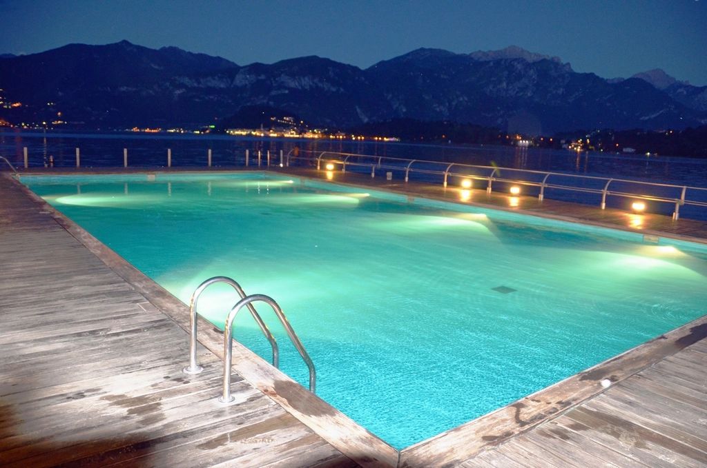 The outdoor swimming pool with loungers alongside